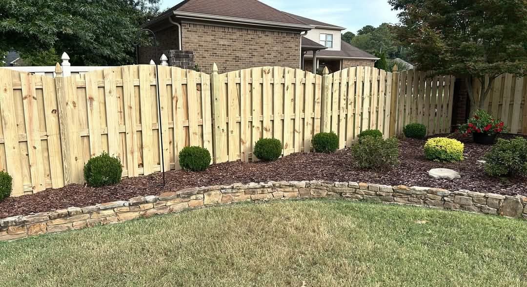 Wood privacy fence behind landscaping